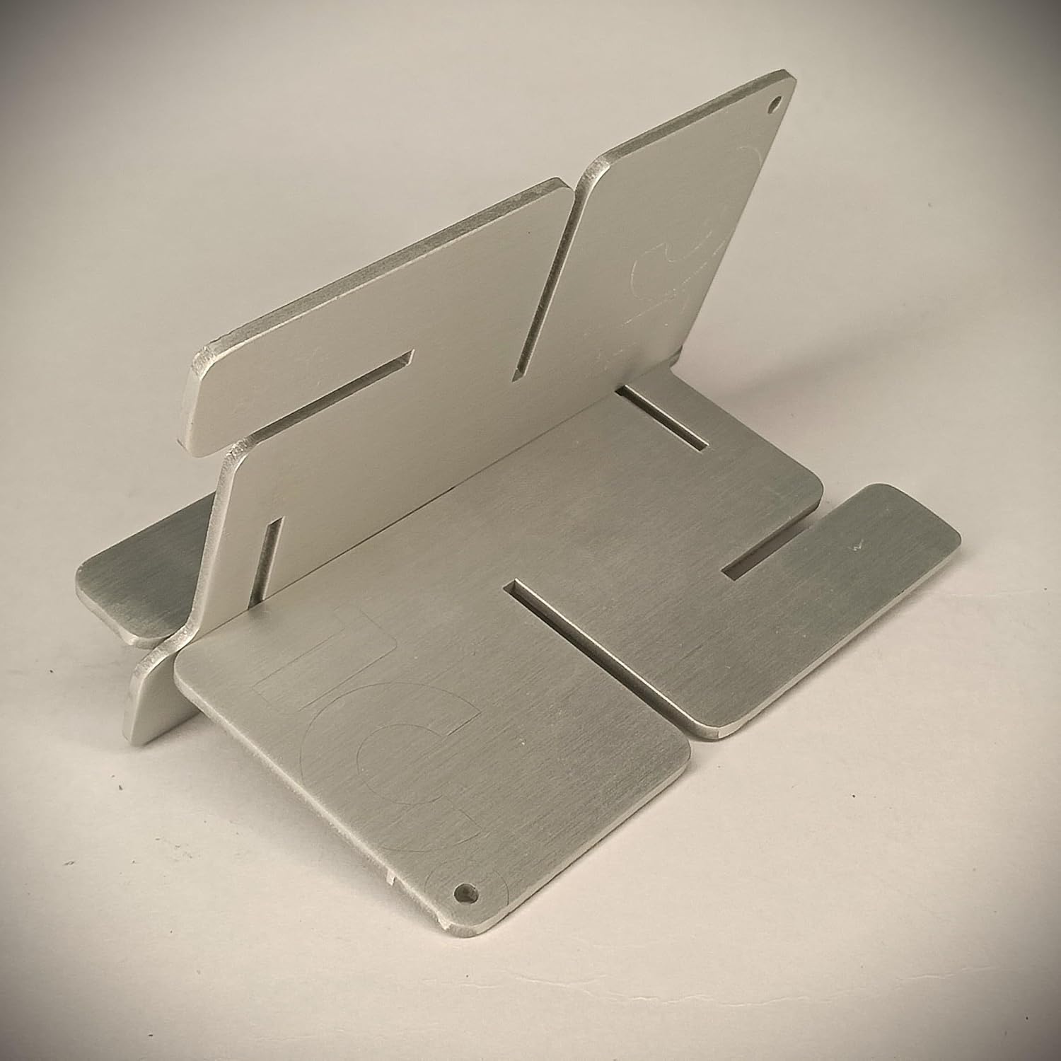 DIY Portable Jigsaw Swastik Slot Stand for Mobile, E-Book, Cards (Metallic Silver)